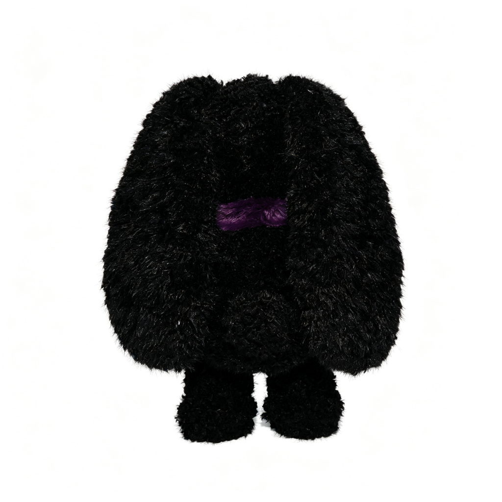 A fuzzy black Plushie Dreadfuls plush stuffed animal with floppy ears and a small purple line for eyes, standing upright.