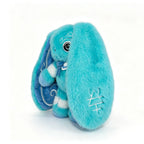 A fluffy blue Dysautonomia Rabbit plush with long ears, white stitched details, and a swirl pattern inside the ear.