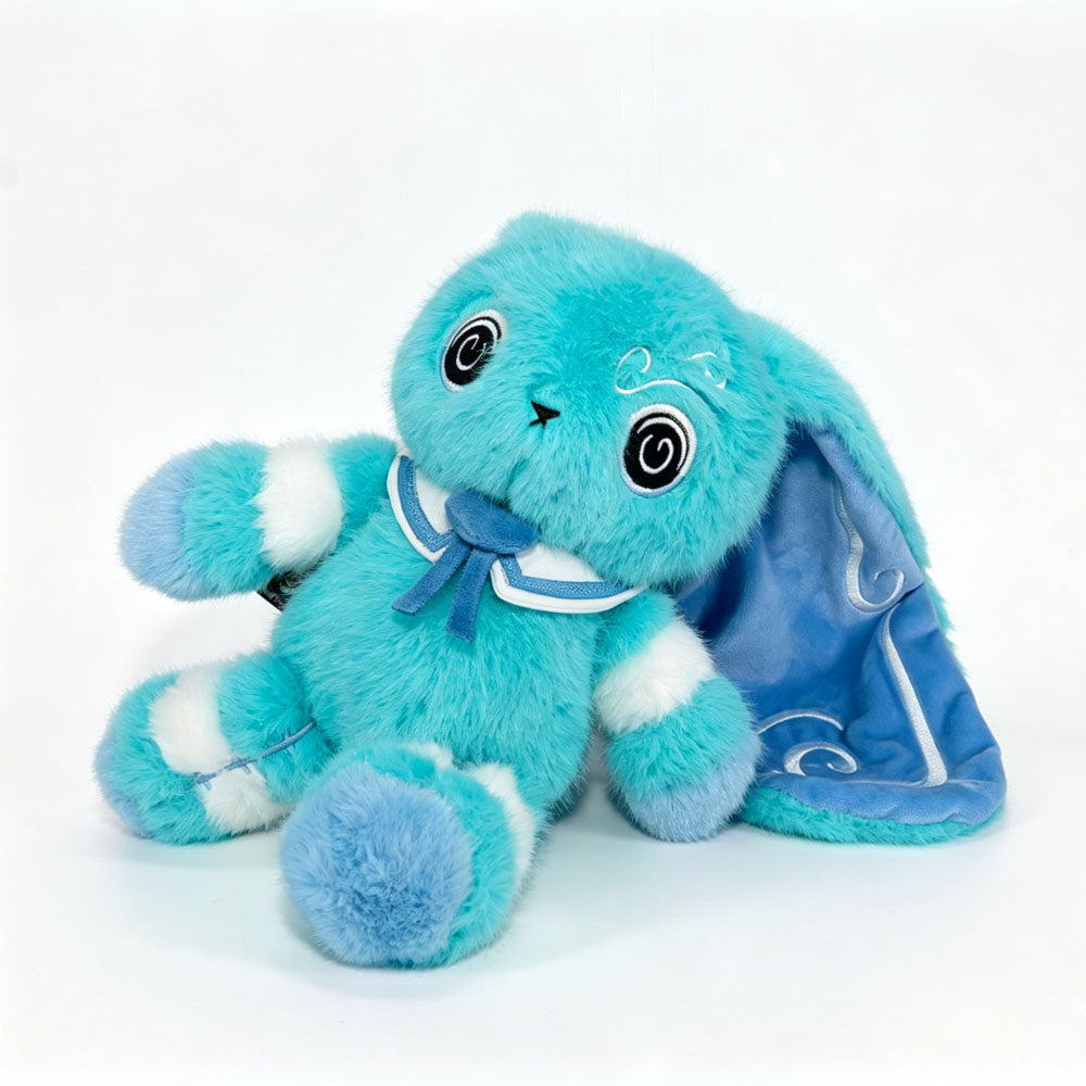 A turquoise Dysautonomia Rabbit with a blue bow and long floppy ears sits on a white background.