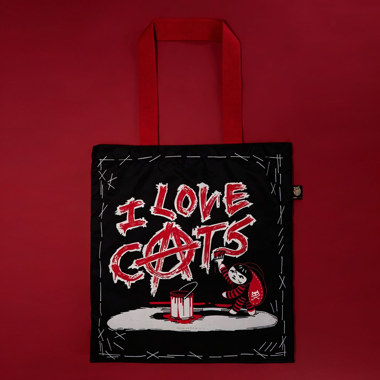 Autographed Emily the Strange and Plushie Dreadful Rabbit collaboration collector set with a black and red goth bunny plush toy, an I Love Cats canvas tote bag, ink pen, coin purse, and signed card by American McGee and Rob Reger.