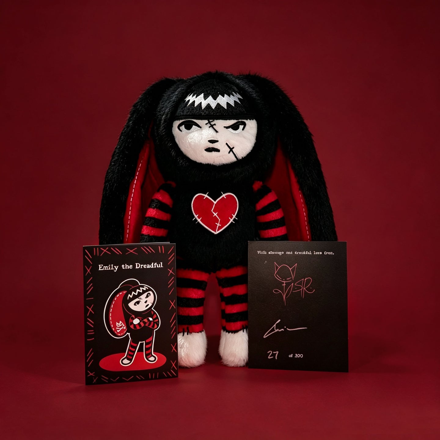 Autographed Emily the Strange and Plushie Dreadful Rabbit collaboration collector set with a black and red goth bunny plush toy, an I Love Cats canvas tote bag, ink pen, coin purse, and signed card by American McGee and Rob Reger.