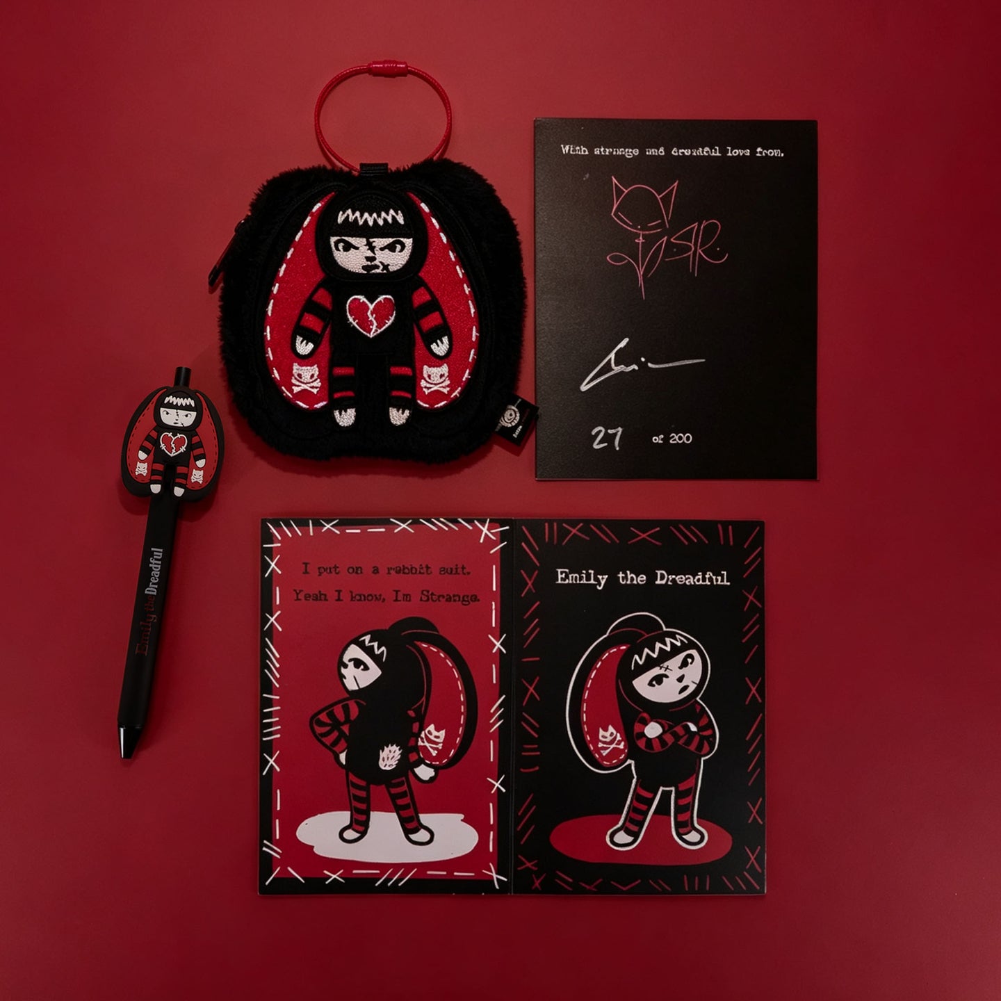 Autographed Emily the Strange and Plushie Dreadful Rabbit collaboration collector set with a black and red goth bunny plush toy, an I Love Cats canvas tote bag, ink pen, coin purse, and signed card by American McGee and Rob Reger.