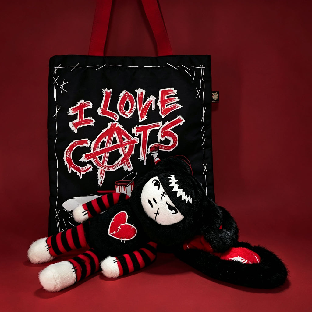 Autographed Emily the Strange and Plushie Dreadful Rabbit collaboration collector set with a black and red goth bunny plush toy, an I Love Cats canvas tote bag, ink pen, coin purse, and signed card by American McGee and Rob Reger.