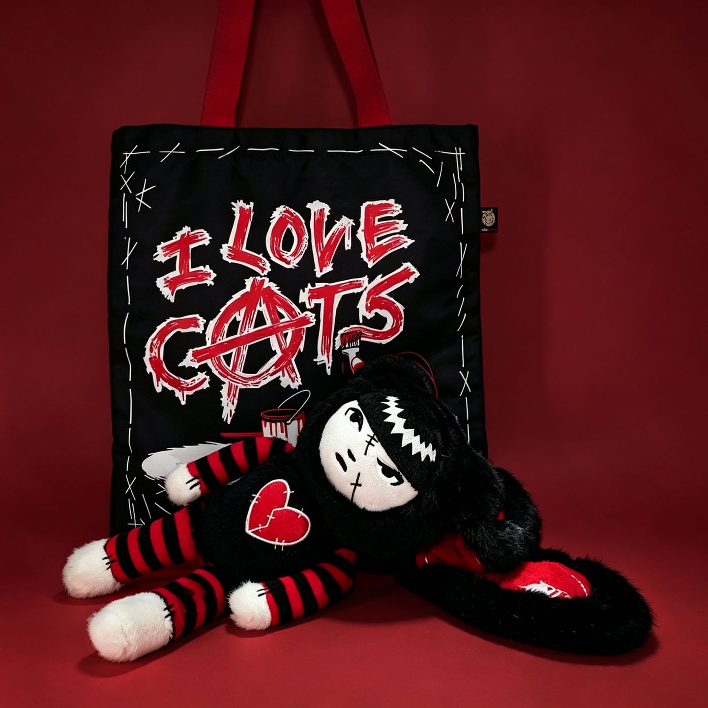 Autographed Emily the Strange and Plushie Dreadful Rabbit collaboration collector set with a black and red goth bunny plush toy, an I Love Cats canvas tote bag, ink pen, coin purse, and signed card by American McGee and Rob Reger.