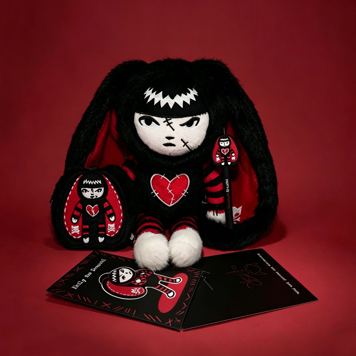 Autographed Emily the Strange and Plushie Dreadful Rabbit collaboration collector set with a black and red goth bunny plush toy, an I Love Cats canvas tote bag, ink pen, coin purse, and signed card by American McGee and Rob Reger.