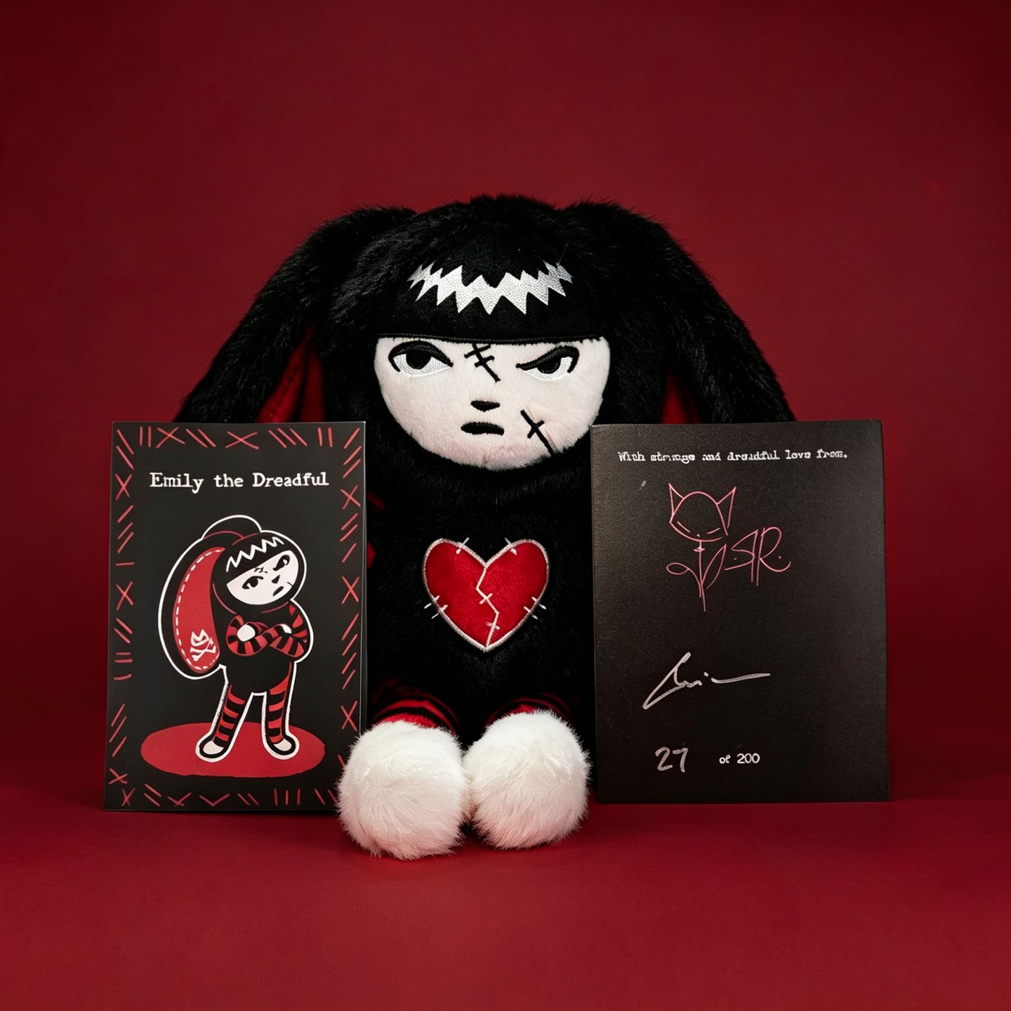 Autographed Emily the Strange and Plushie Dreadful Rabbit collaboration collector set with a black and red goth bunny plush toy, an I Love Cats canvas tote bag, ink pen, coin purse, and signed card by American McGee and Rob Reger.