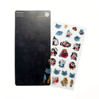 A sheet of colorful cartoon character stickers displayed next to a black backing board on a plain white background. The stickers feature various paws, cats, and fantasy characters in red, blue, white, and gold.