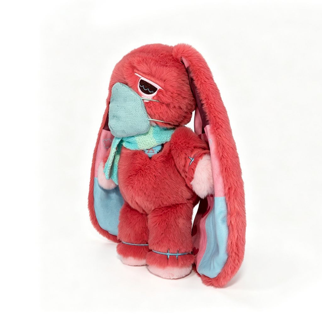 Plush pink bunny with long ears, blue scarf and mask—a charming Long COVID plushie for chronic illness awareness.