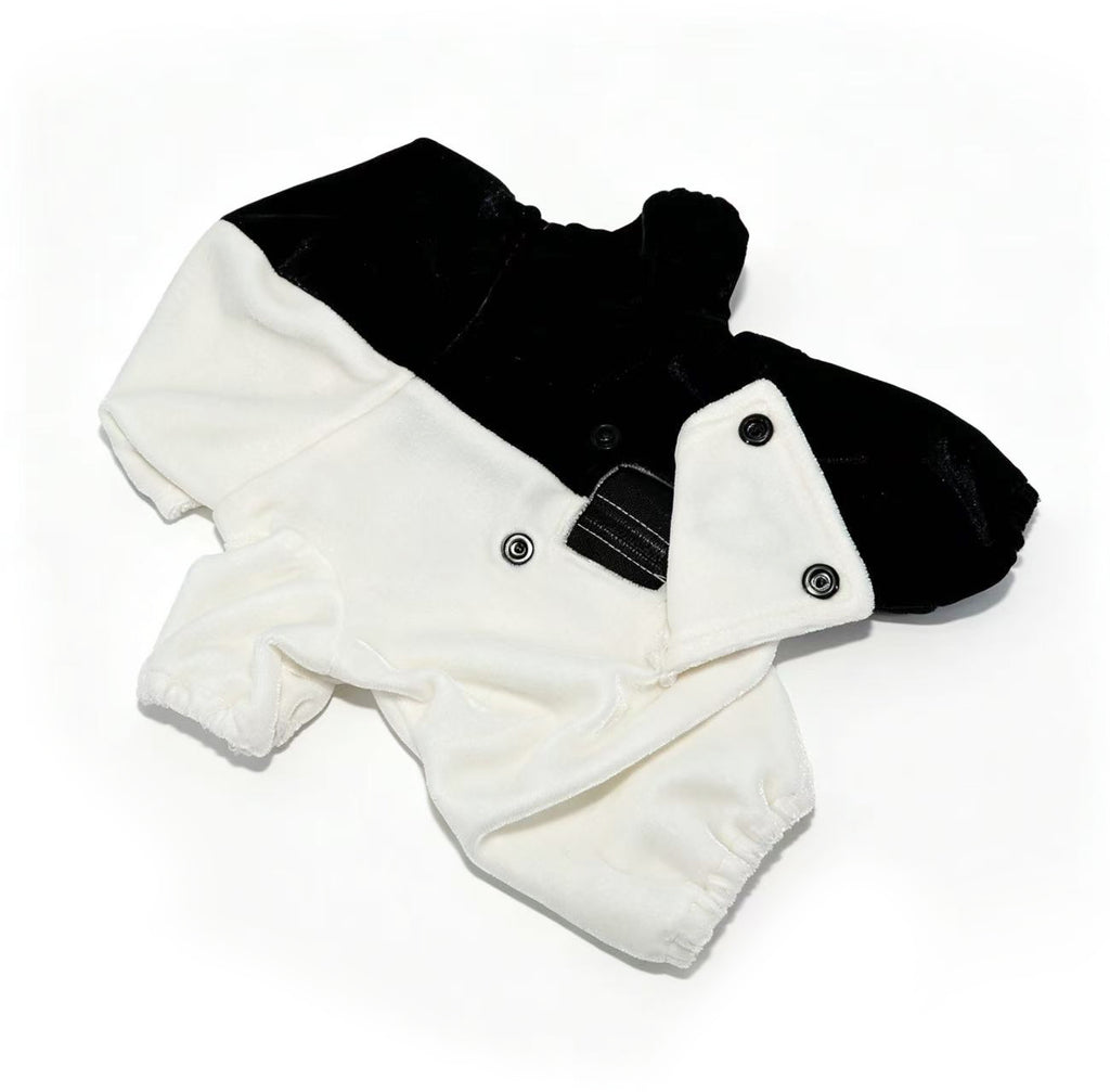 Black and white fleece dog onesie with buttons and elastic cuffs, styled like a Plushie Dreadfuls plushie jumpsuit.