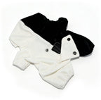 Black and white fleece dog onesie with buttons and elastic cuffs, styled like a Plushie Dreadfuls plushie jumpsuit.