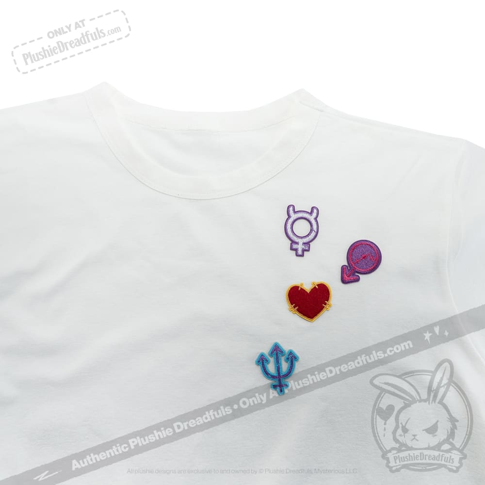 White T-shirt with three gender symbols, a red heart patch, and subtle planetary sign patches on the left chest area.