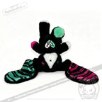 Plush toy bunny with black fur, striped ears, and mismatched accents—an adorable emotional support bunny for comfort.