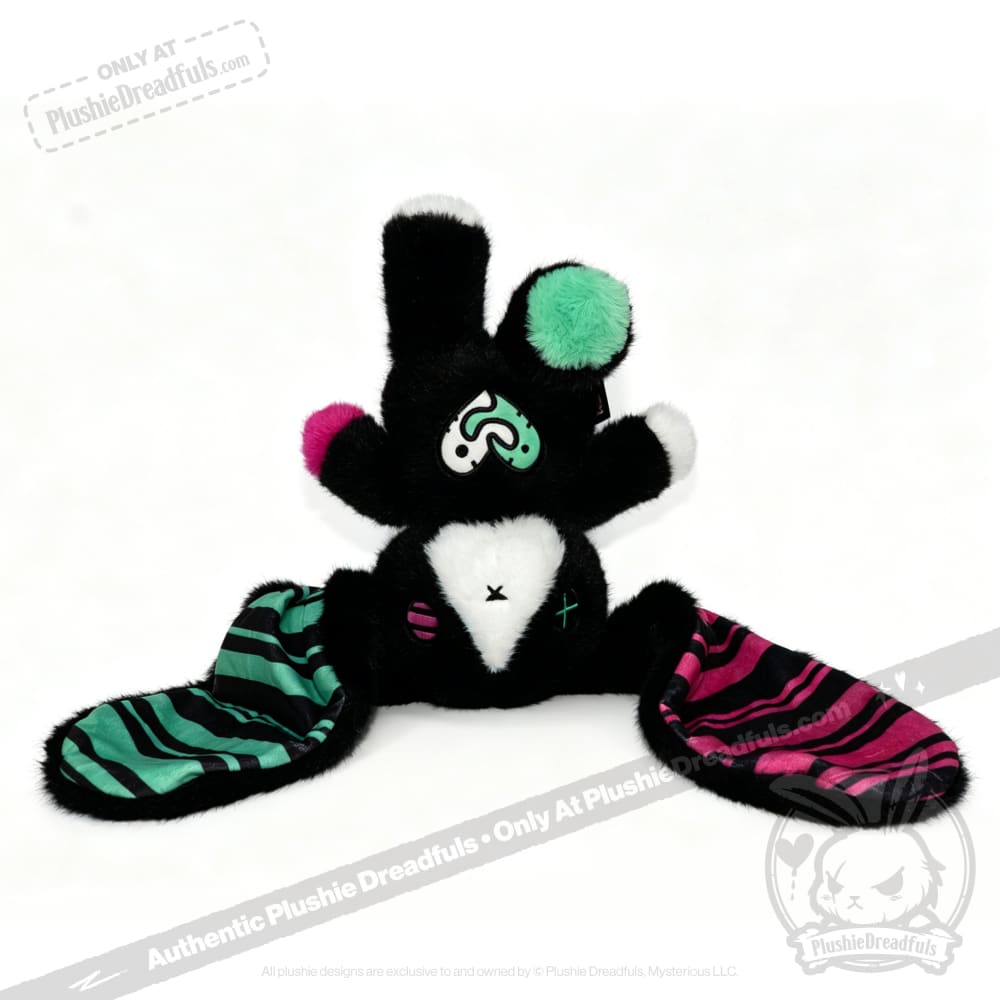 Plush toy bunny with black fur, striped ears, and mismatched accents—an adorable emotional support bunny for comfort.