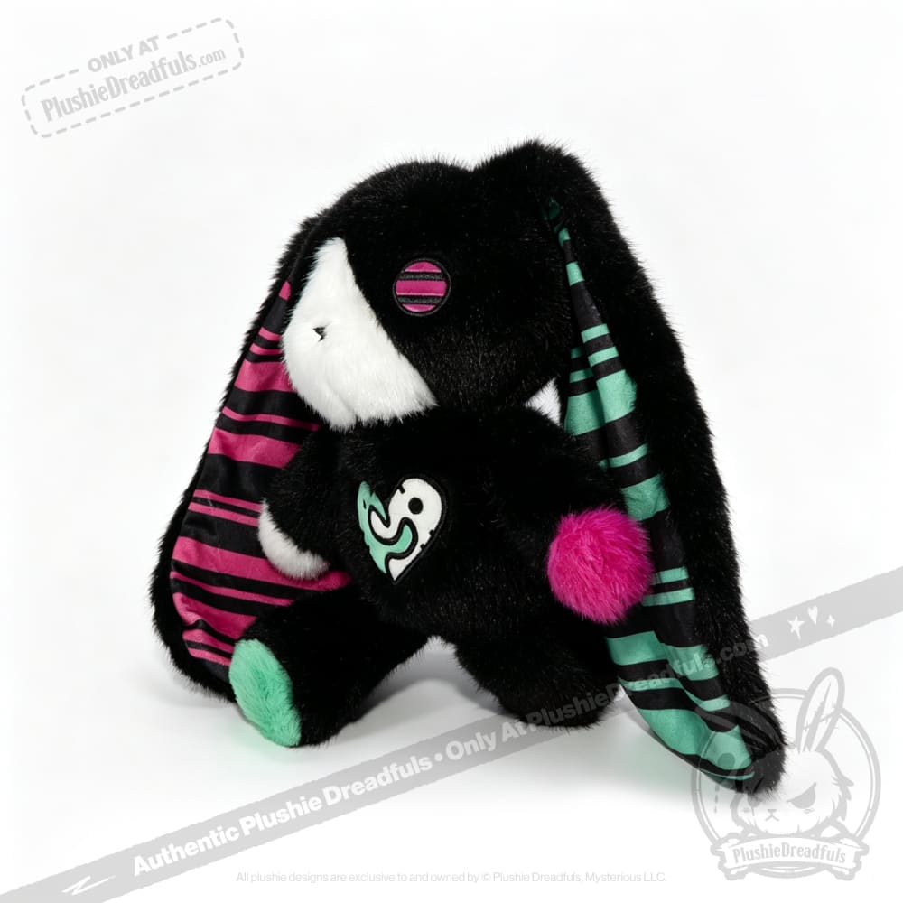 Plush black bunny with striped pink and green ears, heart patch—an emotional support bunny for comfort and care.