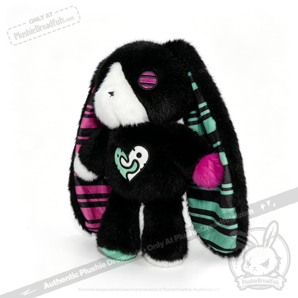 Plush black bunny with striped teal and magenta ears, one button eye—a perfect emotional support bunny for anyones heart.