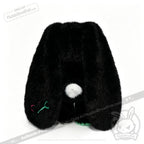 A plush black bunny toy with long ears, a white tail, and colorful stitching—a comforting emotional support bunny.