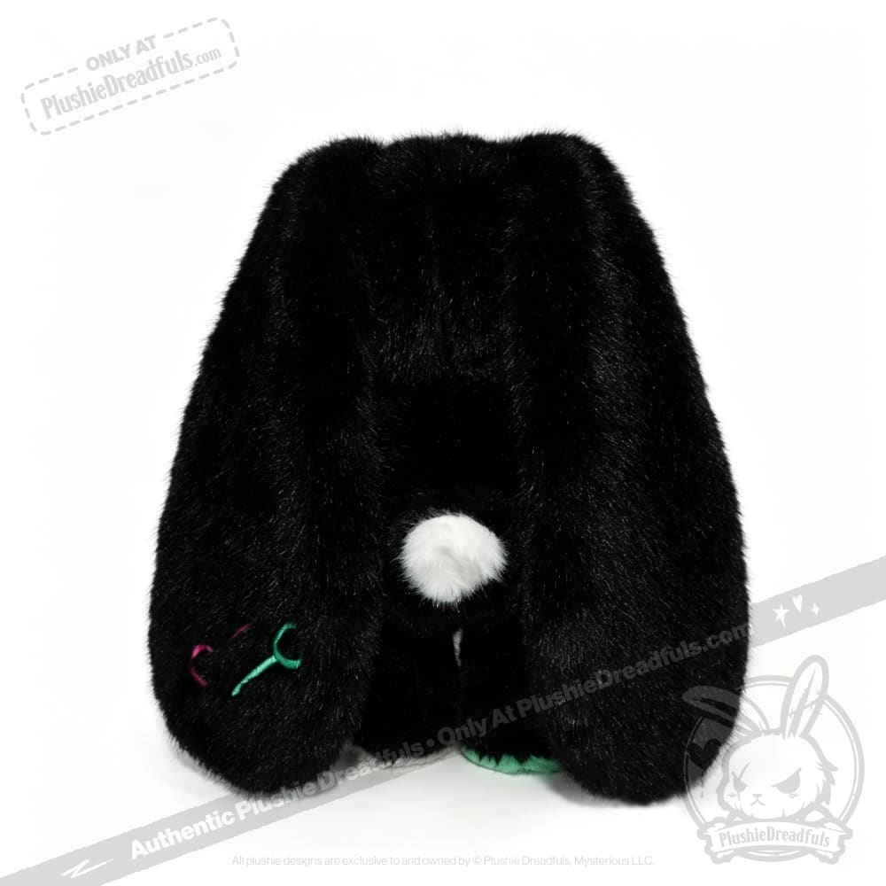 A plush black bunny toy with long ears, a white tail, and colorful stitching—a comforting emotional support bunny.