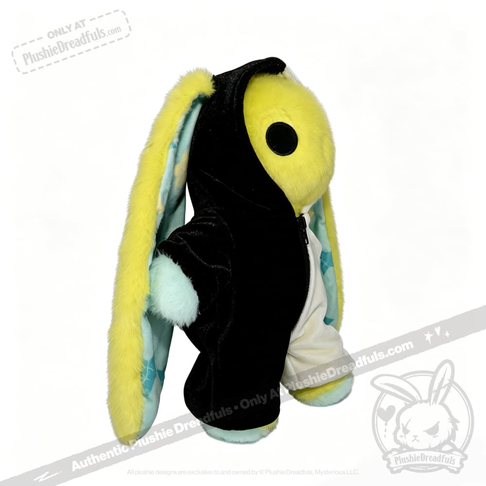 Plushie Dreadfuls regular sized plushies: yellow bunny in a black plushie jumpsuit, mint paws, floppy ears, side view.