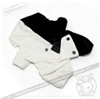 Black and white fleece dog onesie with buttons and elastic cuffs, styled like a Plushie Dreadfuls plushie jumpsuit.