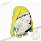 A yellow Plushie Dreadfuls bunny in a plushie jumpsuit hoodie, facing away on a white background.