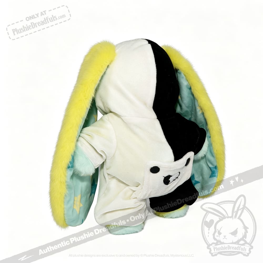 Regular sized Plushie Dreadfuls plush toy in a split hoodie with bunny ears and bear face pocket, seen from the back.