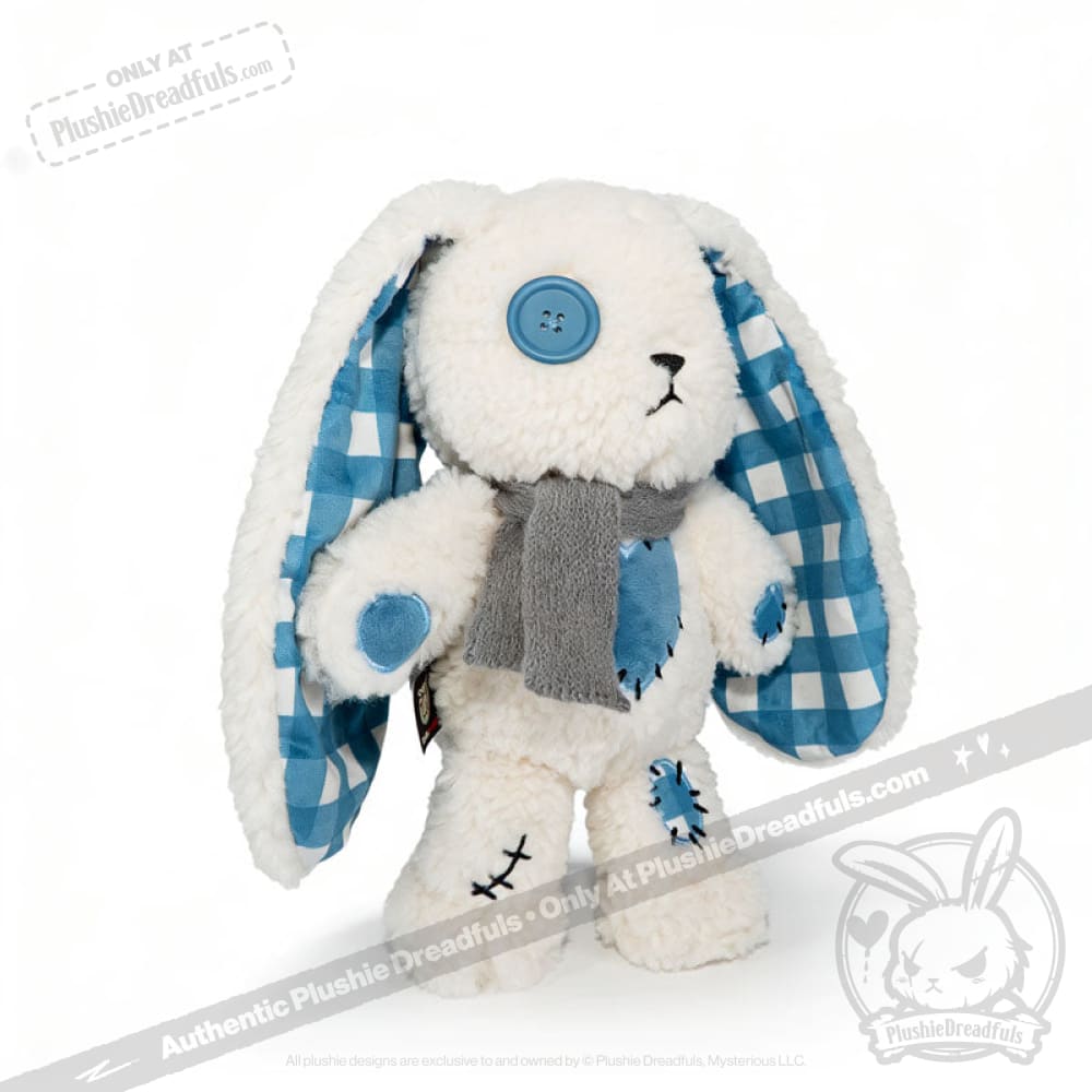 Blueplaid plush bunny toy with blue button eyes, plaid ears, patches, and a gray scarf on a white background.