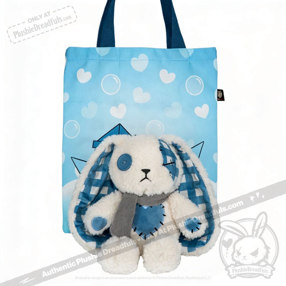 Blueplaid plush bunny with a blue button eye and scarf sits in front of a heart-patterned tote, evoking Seas of Love.