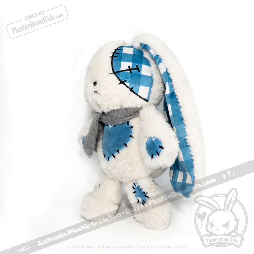Blueplaid plush bunny with blue checkered patches, a gray scarf, and one floppy ear—perfect for Seas of Love gifts.