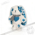 Plush white bunny with blue plaid plush patchwork, button eyes, long ears, gray scarf—ready for Seas of Love adventures.