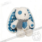 Plush white bunny with blue button eye, patchwork heart, scarf, and Blueplaid plush checkered blue ears.