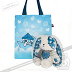 Blue tote bag with hearts and bunny illustration beside a Blueplaid plush bunny, perfect for Seas of Love adventures.