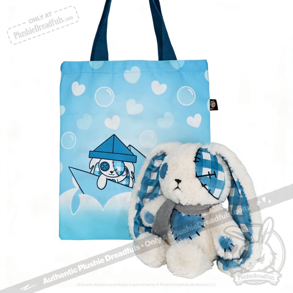 Blue tote bag with hearts and bunny illustration beside a Blueplaid plush bunny, perfect for Seas of Love adventures.