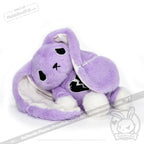 Plush purple bunny with floppy ears, white paws, and a depression awareness semicolon on its chest, lying on its side.