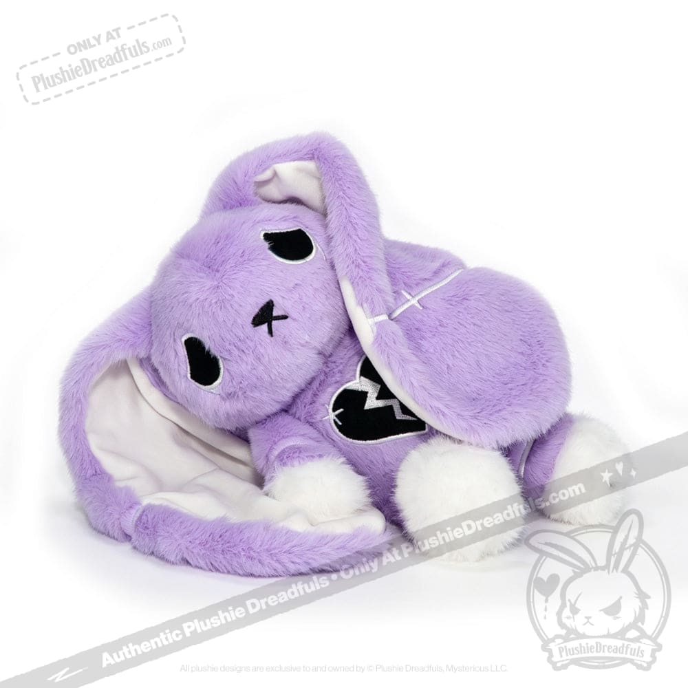 Plush purple bunny with floppy ears, white paws, and a depression awareness semicolon on its chest, lying on its side.