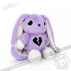 A purple plush bunny with long ears, white paws, and a LIMITED EDITION semicolon symbol stitched on its chest.