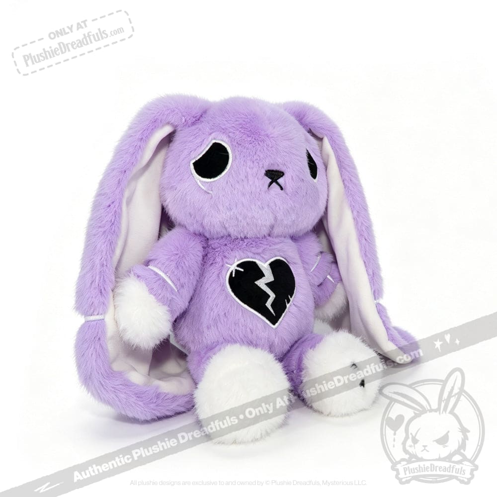 A purple plush bunny with long ears, white paws, and a LIMITED EDITION semicolon symbol stitched on its chest.