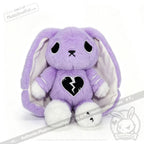 Plush purple bunny with droopy ears, sad eyes, and semicolon symbol on its chest, raising depression awareness.
