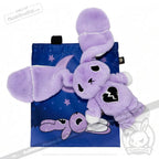 Plush purple bunny with a broken heart patch promotes depression awareness on a blue bag under a crescent moon.