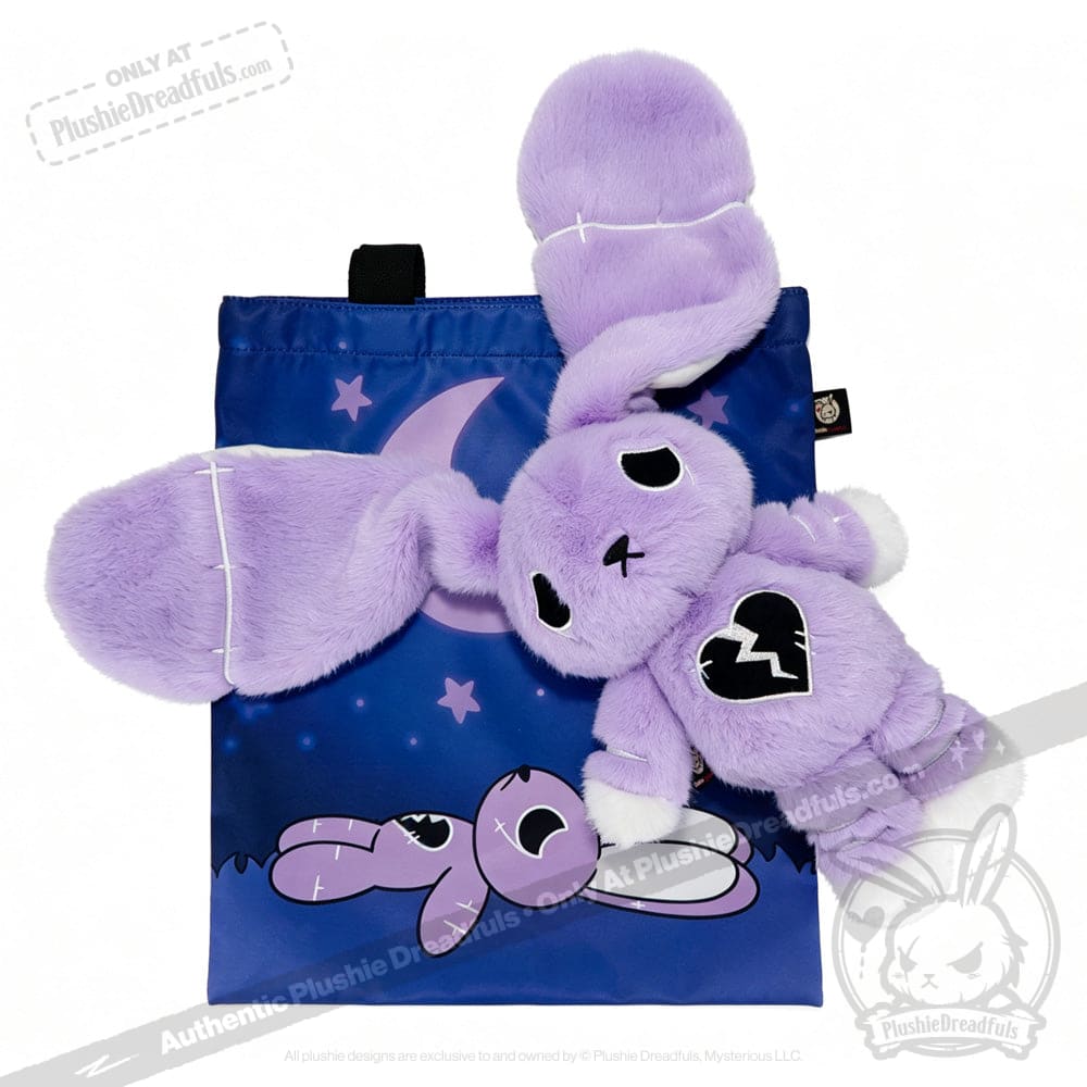 Plush purple bunny with a broken heart patch promotes depression awareness on a blue bag under a crescent moon.