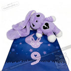 Purple plush bunny with a semicolon symbol and broken heart on its chest lies on a starry mat. LIMITED EDITION.