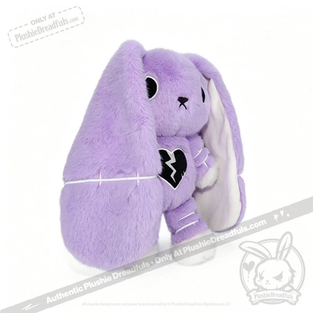 Purple stuffed bunny with floppy ears, black broken heart patch, semicolon symbol, and white stitches—depression awareness.