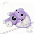 A LIMITED EDITION plush purple bunny with a broken heart emblem, white paws, and one floppy ear lined with white fabric.