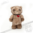 A brown Plushie Dreadfuls bear with a red heart and black collar stands upright on a white background.