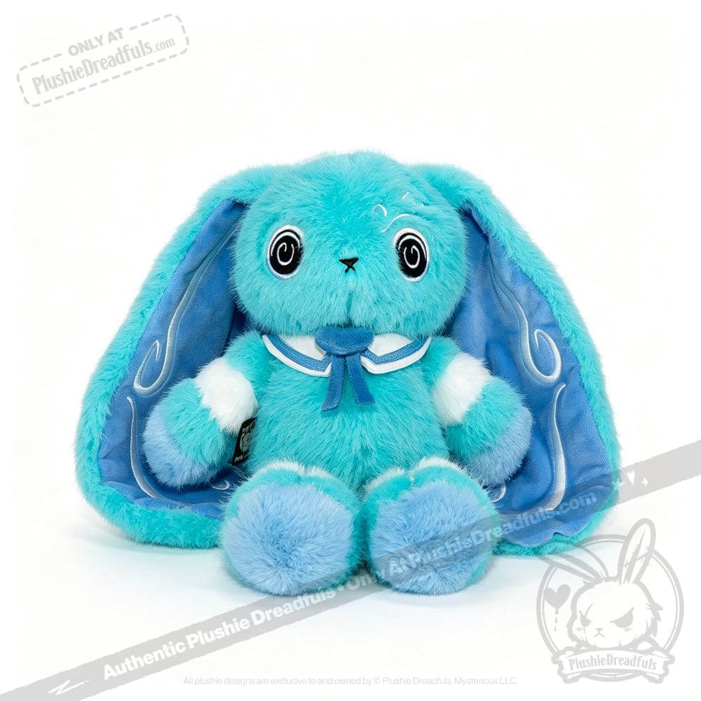 A blue Dysautonomia Rabbit with long floppy ears, black button eyes, and a sailor collar sits facing forward.