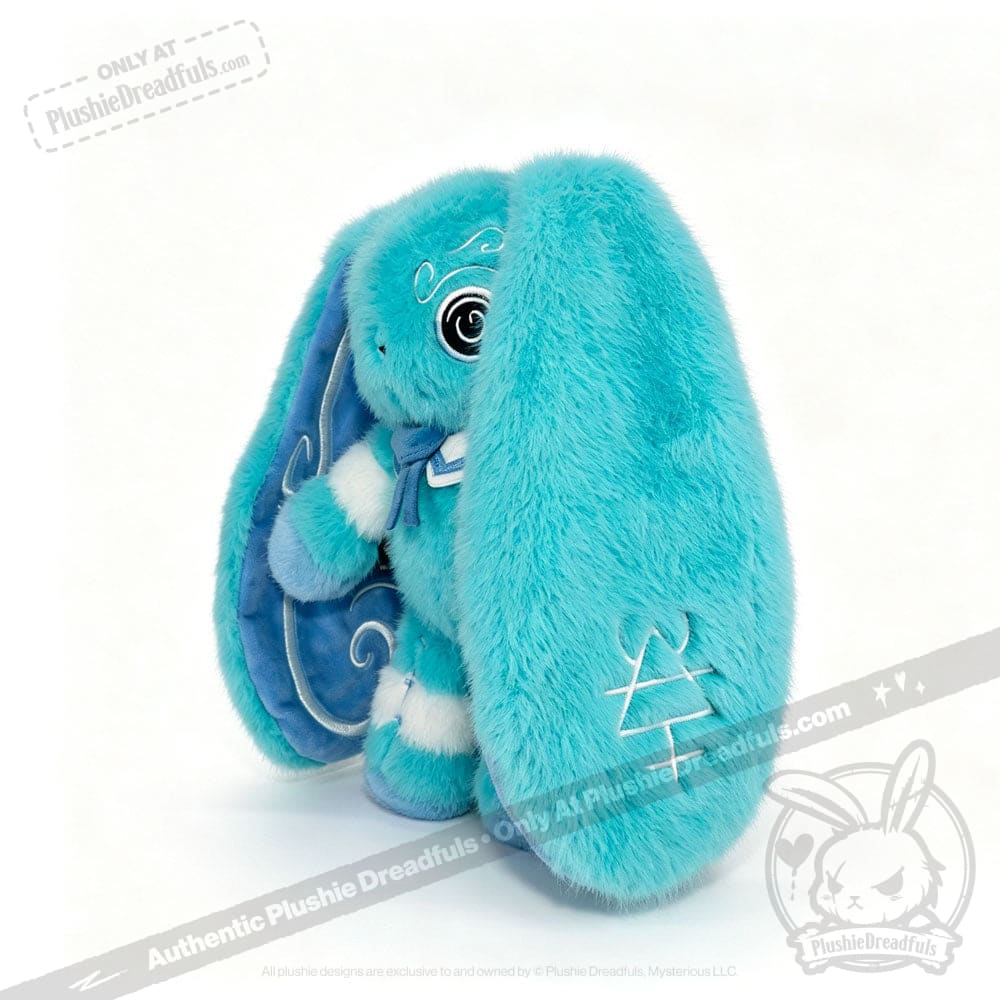 A fluffy blue Dysautonomia Rabbit plush with long ears, white stitched details, and a swirl pattern inside the ear.