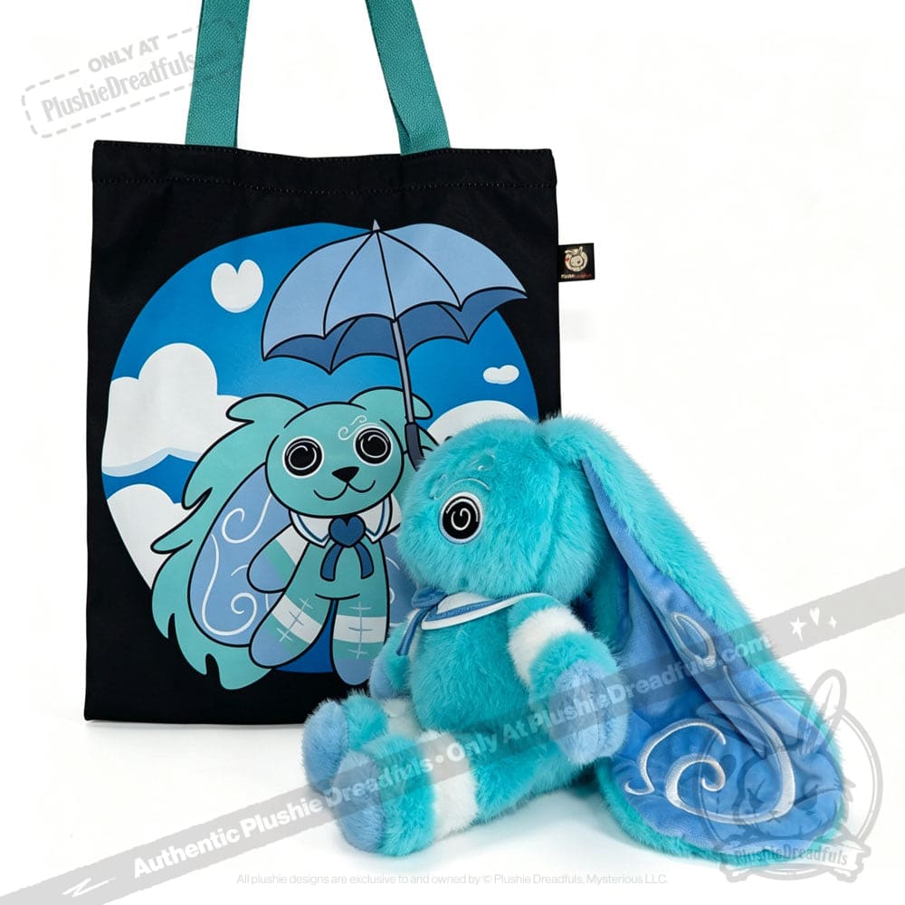 Blue plush Dysautonomia Rabbit sits beside a black tote bag featuring the bunny with an umbrella on a blue background.