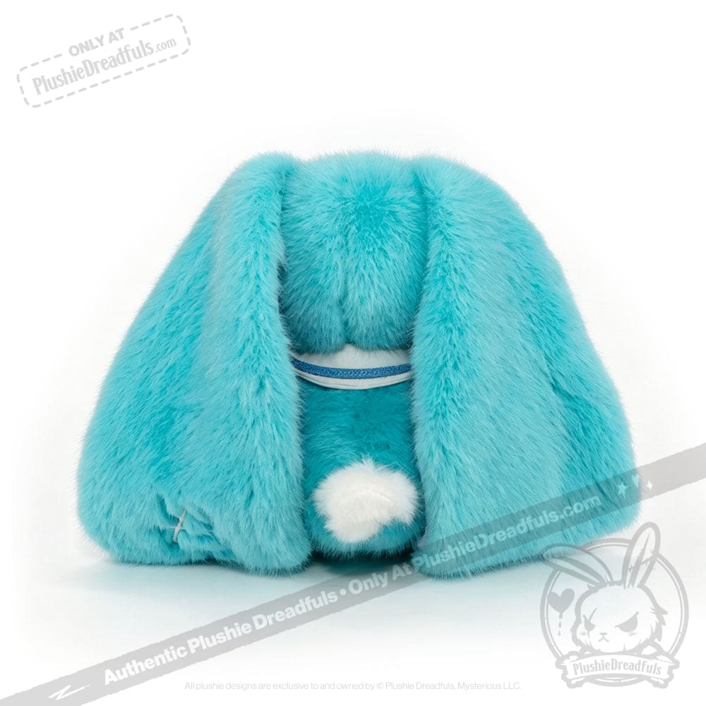 A plush blue Dysautonomia Rabbit sits with its back facing forward, floppy ears down, and white fluffy tail showing.