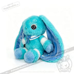 A blue plush Dysautonomia Rabbit with floppy ears, swirl designs, and a ribbon—perfect for dysautonomia awareness.