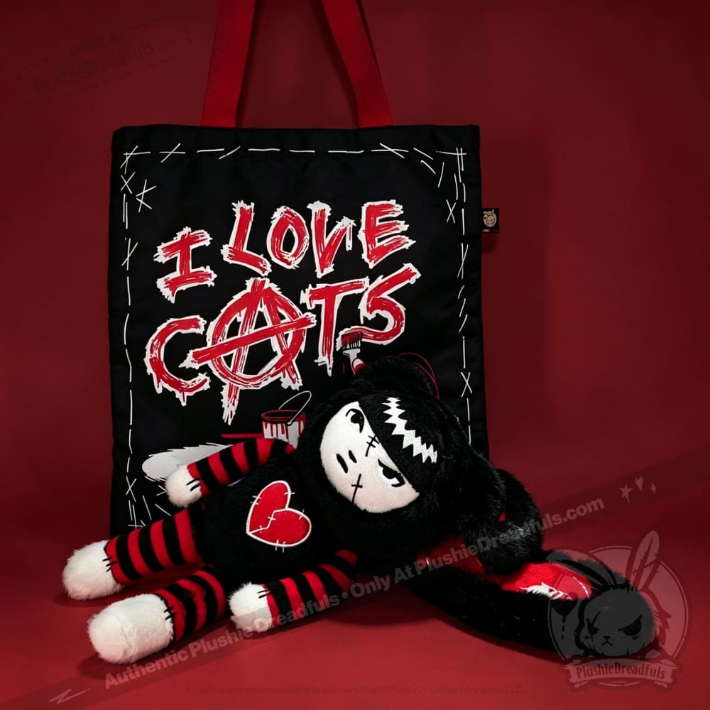 Autographed Emily the Strange and Plushie Dreadful Rabbit collaboration collector set with a black and red goth bunny plush toy, an I Love Cats canvas tote bag, ink pen, coin purse, and signed card by American McGee and Rob Reger.