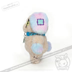 A Plushie Dreadfuls Emotional Neglect Puppy with blue, pink, and cream fur stands on a white background.